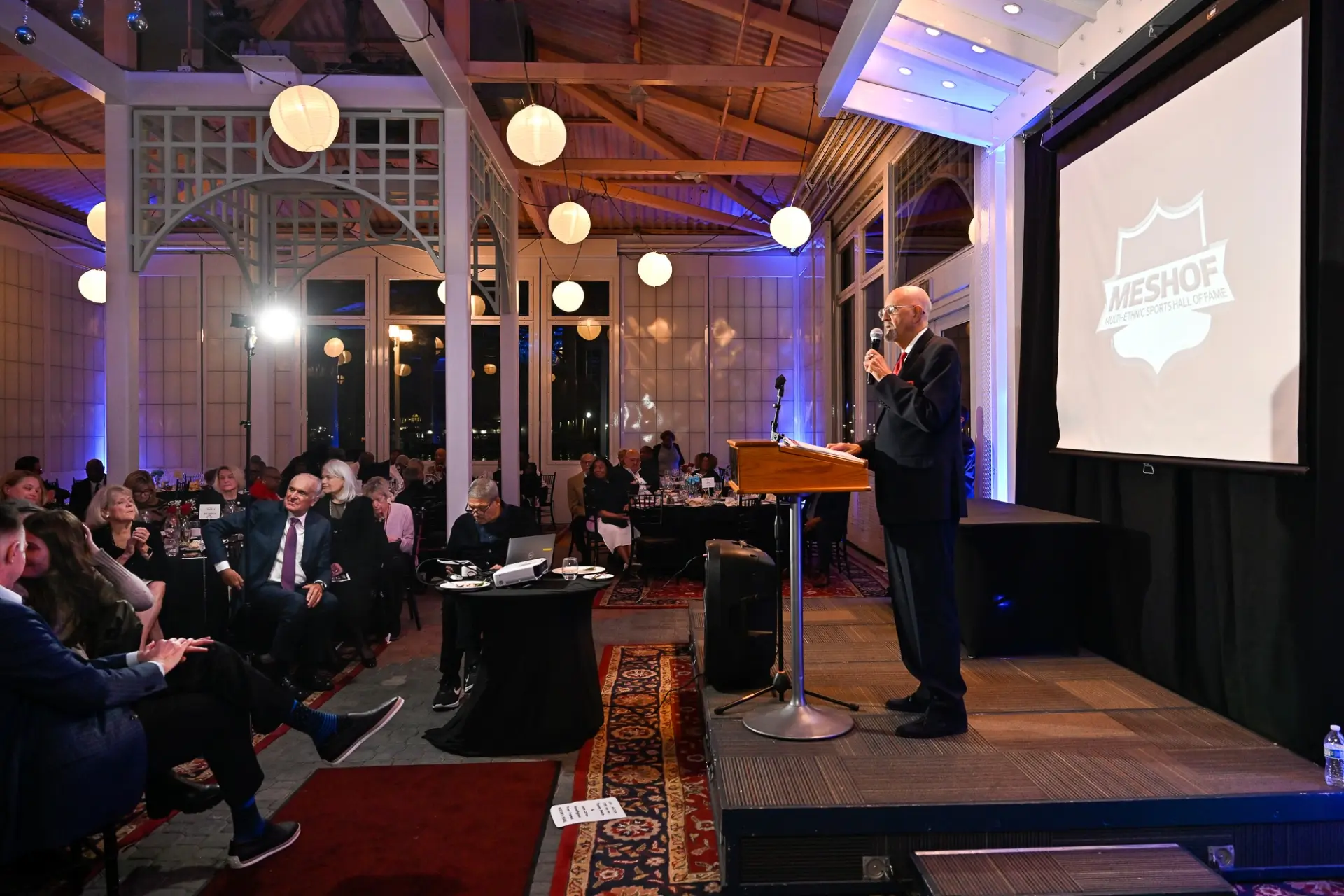 MESHOF speaker addressing guests at an induction ceremony